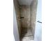Enclosed shower featuring floor-to-ceiling tile work and a modern shower head and fixture at 3013 Rockview Dr, Loganville, GA 30052