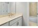 Well-lit bathroom featuring a vanity with quartz countertop and cabinet storage, plus a tile surround tub at 630 Silva St, Cumming, GA 30040