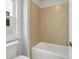 Bathroom featuring tile surround tub next to window and toilet at 630 Silva St, Cumming, GA 30040