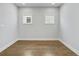 Bedroom with hardwood floors and bright natural lighting at 630 Silva St, Cumming, GA 30040