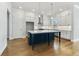 Modern kitchen features white cabinets, a navy blue island with white countertop, and stainless steel appliances at 630 Silva St, Cumming, GA 30040