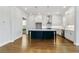 Modern kitchen features white cabinets, a navy blue island with white countertop, and stainless steel appliances at 630 Silva St, Cumming, GA 30040