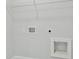 Utility hookups inside laundry room with wire shelf at 630 Silva St, Cumming, GA 30040