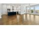 Open-concept living room features an island kitchen with hardwood flooring and natural light at 630 Silva St, Cumming, GA 30040
