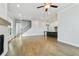 Open-concept living room and kitchen with hardwood floors and island at 630 Silva St, Cumming, GA 30040