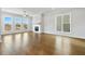 Spacious living room with large windows, fireplace, hardwood floors and ceiling fan at 630 Silva St, Cumming, GA 30040