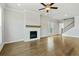 Spacious living room with hardwood floors, fireplace, and ceiling fan at 630 Silva St, Cumming, GA 30040