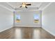 Spacious main bedroom features hardwood floors, tray ceiling, and natural light at 630 Silva St, Cumming, GA 30040