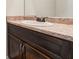 Close up on a sink with a decorative faucet, granite countertop, and dark wood cabinetry in a bathroom at 1831 Broad River Rd, Atlanta, GA 30349