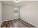 This bedroom features wood-look floors, neutral paint and a single window at 1831 Broad River Rd, Atlanta, GA 30349