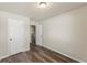 This bedroom features wood-look floors, neutral paint and two doors at 1831 Broad River Rd, Atlanta, GA 30349