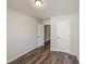 This bedroom features wood-look floors, neutral paint and two doors at 1831 Broad River Rd, Atlanta, GA 30349