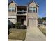 Charming two-story townhome with a brick facade, balcony, and single-car garage at 1831 Broad River Rd, Atlanta, GA 30349