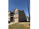 Side view of a two-story townhome featuring brick and vinyl siding at 1831 Broad River Rd, Atlanta, GA 30349