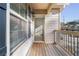 Covered front porch with wooden decking, black railings, and a view into a neutrally painted home at 1831 Broad River Rd, Atlanta, GA 30349