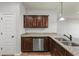 Kitchen with granite counters, dark cabinets, and stainless steel dishwasher at 1831 Broad River Rd, Atlanta, GA 30349