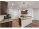 Kitchen with dark cabinets, granite countertops, stainless steel appliances, and hardwood floors at 1831 Broad River Rd, Atlanta, GA 30349