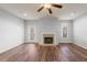 Living room showcasing the brick fireplace, wood laminate floors, and ceiling fan at 1831 Broad River Rd, Atlanta, GA 30349