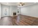 Open-concept living room featuring a fireplace, wood flooring, and natural light at 1831 Broad River Rd, Atlanta, GA 30349
