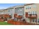 Exterior view of multiple townhomes and fenced in backyards, each with private deck at 2517 Ashwicke Se Dr, Atlanta, GA 30339