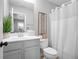 Cozy bathroom featuring gray vanity, toilet, white shower curtain, and neutral decor at 2517 Ashwicke Se Dr, Atlanta, GA 30339