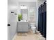 Bathroom with gray vanity, toilet, and navy blue shower curtain at 2517 Ashwicke Se Dr, Atlanta, GA 30339