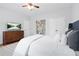 Spacious bedroom with hardwood floors, a comfortable bed, a dresser with TV, and a closet at 2517 Ashwicke Se Dr, Atlanta, GA 30339