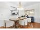 Bright dining area with modern chandelier, table, chairs, and hardwood floors, perfect for entertaining at 2517 Ashwicke Se Dr, Atlanta, GA 30339