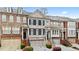 Beautiful townhome exterior featuring brick, stone accents, and symmetrical windows with black shutters at 2517 Ashwicke Se Dr, Atlanta, GA 30339