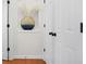 Hallway with a neutral palette, hardwood floors, and a unique decorative vase in a recessed shelf at 2517 Ashwicke Se Dr, Atlanta, GA 30339