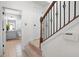 Hallway with staircase leading to an open bathroom with gray cabinets and tiled flooring at 2517 Ashwicke Se Dr, Atlanta, GA 30339
