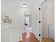 Bright hallway with hardwood floors, white walls, and access to a laundry room and bedroom or office at 2517 Ashwicke Se Dr, Atlanta, GA 30339