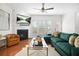 Inviting living room boasts a cozy fireplace, a ceiling fan, and lots of natural light from the large windows at 2517 Ashwicke Se Dr, Atlanta, GA 30339