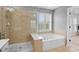 Large main bathroom featuring a double vanity, soaking tub, and a shower with glass doors at 2517 Ashwicke Se Dr, Atlanta, GA 30339