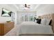 Main bedroom featuring tray ceilings, natural light, and a large decorative TV at 2517 Ashwicke Se Dr, Atlanta, GA 30339