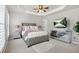 Well-lit main bedroom with a tray ceiling, plush carpet, a large bed, and a modern dresser at 2517 Ashwicke Se Dr, Atlanta, GA 30339
