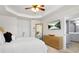 Primary bedroom showcasing a decorative TV, tray ceilings, natural light, and hardwood floors at 2517 Ashwicke Se Dr, Atlanta, GA 30339