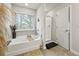 The bathroom is equipped with a tub, shower, and neutral-toned decor at 7005 Livia Pt, Riverdale, GA 30296