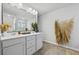 Bathroom featuring double sinks, a large mirror, and stylish decorations at 7005 Livia Pt, Riverdale, GA 30296