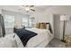 This bedroom has great natural light, a ceiling fan and carpet floors at 7005 Livia Pt, Riverdale, GA 30296