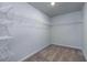 This is a closet with carpeted floors and metal racks for storage at 7005 Livia Pt, Riverdale, GA 30296