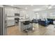 Modern kitchen with granite countertops, stainless steel appliances, and adjacent living area at 7005 Livia Pt, Riverdale, GA 30296