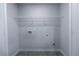 This is a laundry room with gray floors and washer/dryer hookups at 7005 Livia Pt, Riverdale, GA 30296