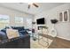 Bright living room with modern decor, ceiling fan, and natural light at 7005 Livia Pt, Riverdale, GA 30296