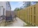Cozy backyard patio featuring a modern patio set, wooden fence, and ample space at 7005 Livia Pt, Riverdale, GA 30296