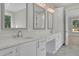 Bathroom with dual sinks, custom cabinets, marble counters, and modern light fixtures at 123 Candler Loop, Acworth, GA 30101