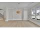 Elegant dining room with hardwood floors, a stylish chandelier, and natural light from windows at 123 Candler Loop, Acworth, GA 30101