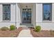 Close-up of the home's front entrance with dark doors and stone steps framed by brick at 123 Candler Loop, Acworth, GA 30101