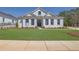 Beautifully landscaped front yard with a lush lawn and a charming white brick home at 123 Candler Loop, Acworth, GA 30101