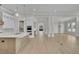Open-concept kitchen and living room with large island, custom cabinets, and hardwood floors at 123 Candler Loop, Acworth, GA 30101